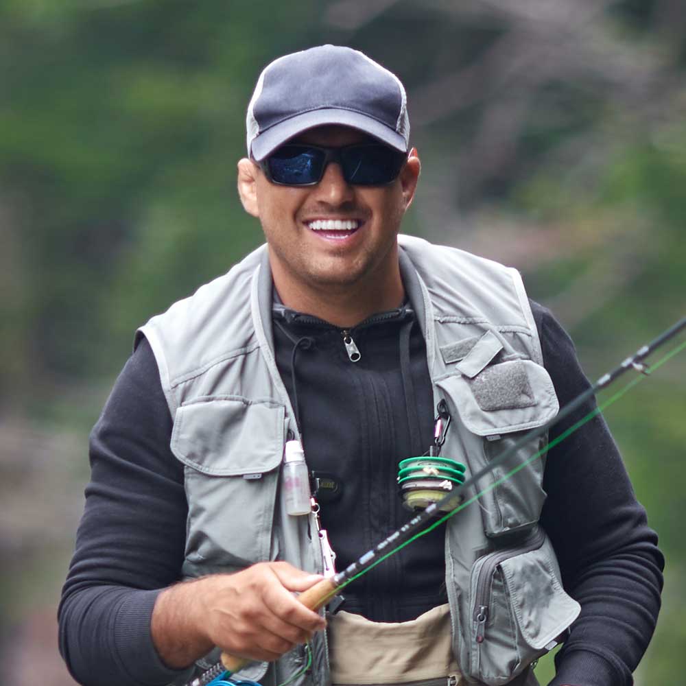 Cheerful Man Fishing In Rough Mountain River
