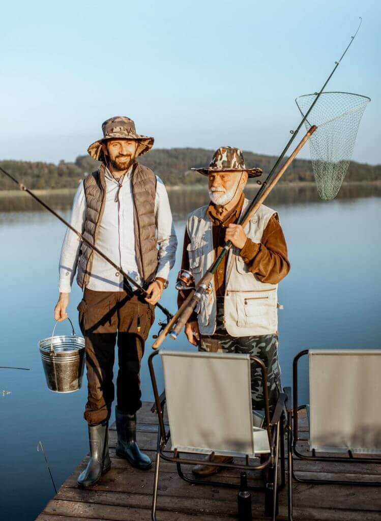 Grandfather With Adult Son Fishing On The Lake E1625545220447 749x1024
