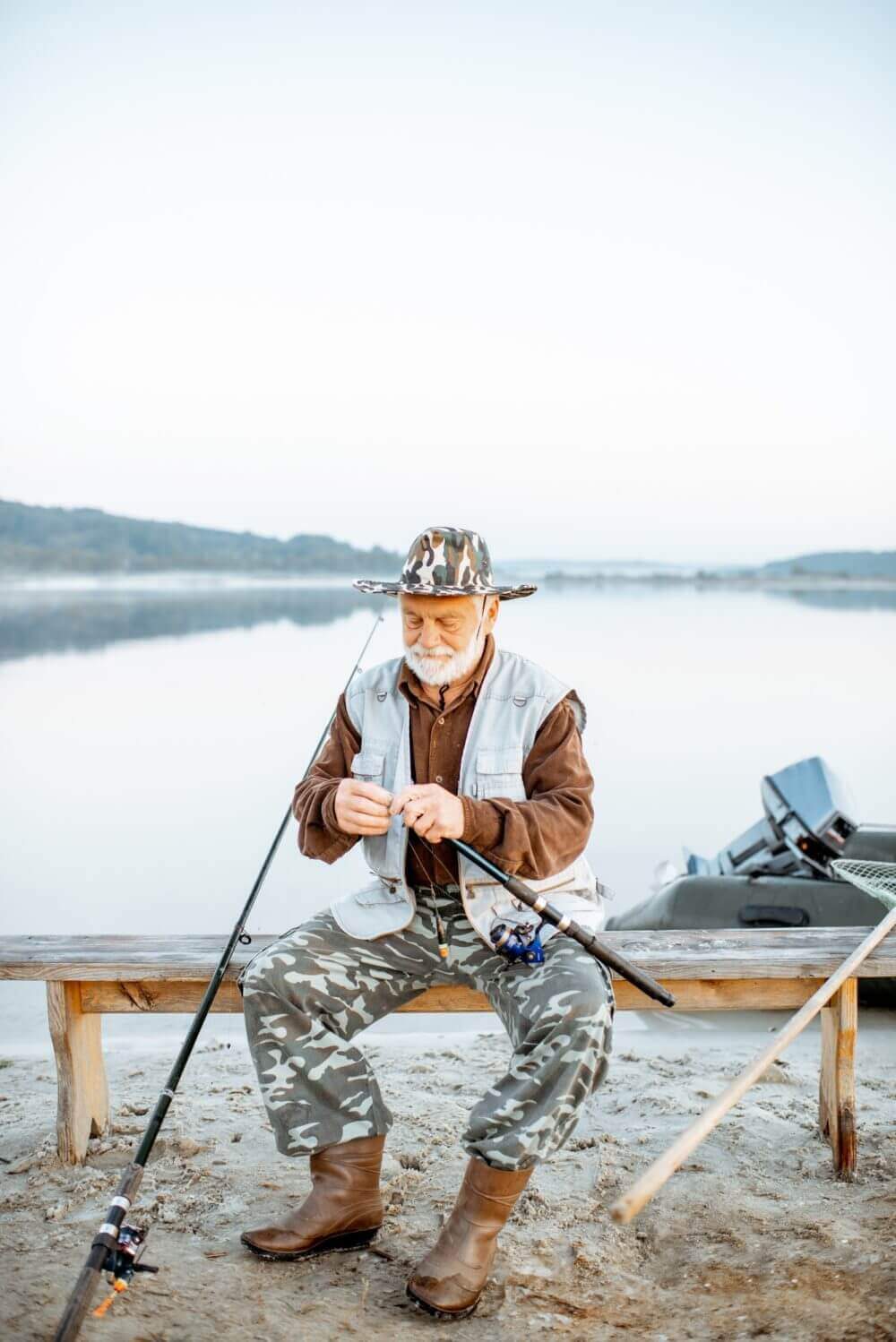 Senior Man Fishing On The Lake E1625801355637